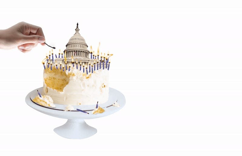A hand lighting a candle on a birthday cake that has the Capitol building on top of it.