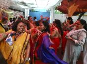 Hindu women dance to celebrate ahead of a groundbreaking ceremony of a temple dedicated to the Hindu god Ram in Ayodhya, at the Vishwa Hindu Parishad, or World Hindu Council, headquarters in New Delhi, India, Wednesday, Aug. 5, 2020. The coronavirus is restricting a large crowd, but Hindus were joyful before Prime Minister Narendra Modi breaks ground Wednesday on a long-awaited temple of their most revered god Ram at the site of a demolished 16th century mosque in northern India. (AP Photo/Manish Swarup)