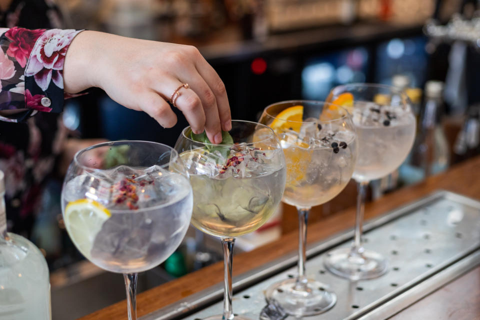 hand garnishing drinks at the bar