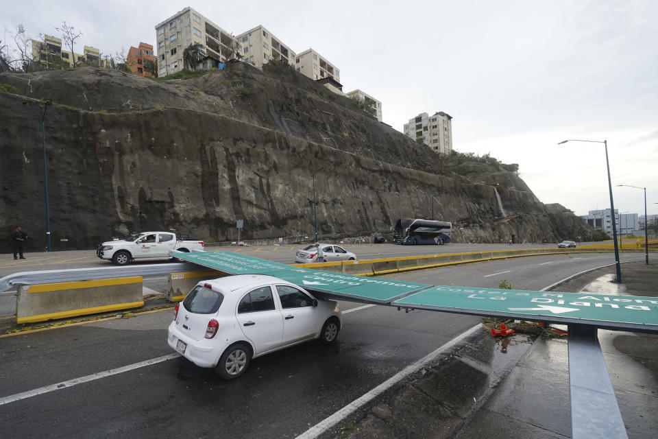 A traffic sign lays on a car after Hurricane Otis ripped through Acapulco, Mexico, Wednesday, Oct. 25, 2023. Hurricane Otis ripped through Mexico's southern Pacific coast as a powerful Category 5 storm, unleashing massive flooding, ravaging roads and leaving large swaths of the southwestern state of Guerrero without power or cellphone service. (AP Photo/Marco Ugarte)