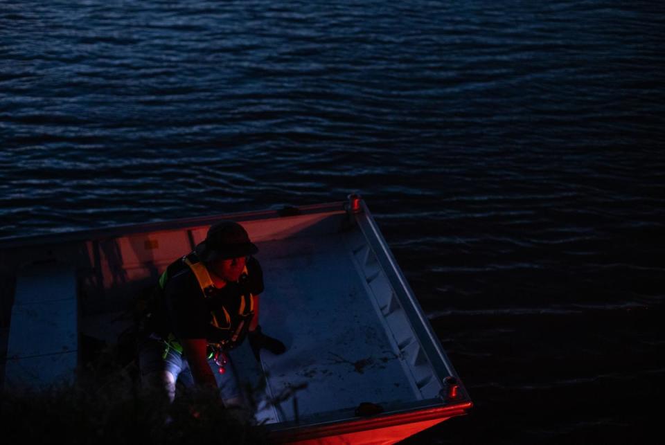 Firefighter EMTs return from a failed water rescue, leaving a group of migrants stranded on an island in the Rio Grande, after the boat’s motor failed against the water’s current in Eagle Pass on Feb. 04, 2024.