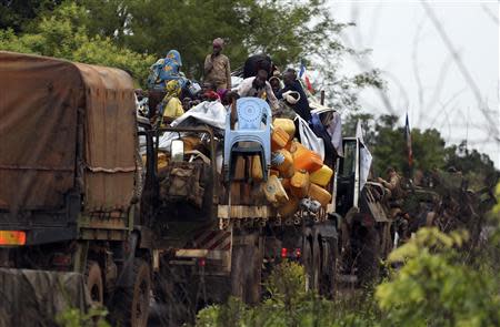 Muslims fleeing sectarian violence are seen on top of a truck with their belongings, on the road between Bangui and Sibut, on a convoy being escorted by French peacekeepers to the south eastern town of Bambari April 20, 2014. Picture taken April 20, 2014. REUTERS/Emmanuel Braun