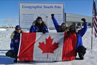 The Test Your Limits team celebrates reaching the South Pole for Canada with the Canadian flag.