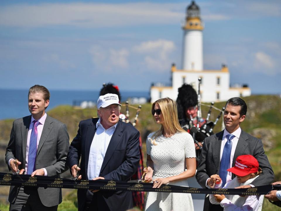 Donald Trump cuts a ribbon on the 9th tee at his Trump Turnberry Resort surrounded by Eric, Don Jr and Ivanka in 2016. (Getty Images)