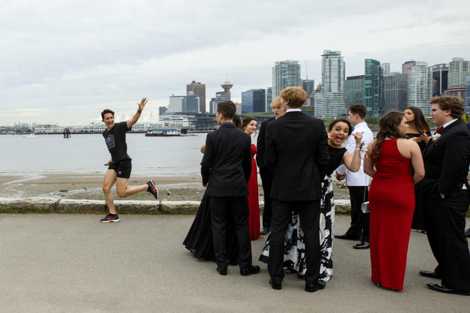 Prime Minister Justin Trudeau jogs past a group of high school students dressed for their prom in Vancouver, British Columbia, Canada on May 19, 2017. Picture taken on May 19, 2017.    Adam Scotti/Courtesy Prime Minister's Office/Handout via REUTERS  ATTENTION EDITORS - THIS IMAGE WAS PROVIDED BY A THIRD PARTY. EDITORIAL USE ONLY.   TPX IMAGES OF THE DAY