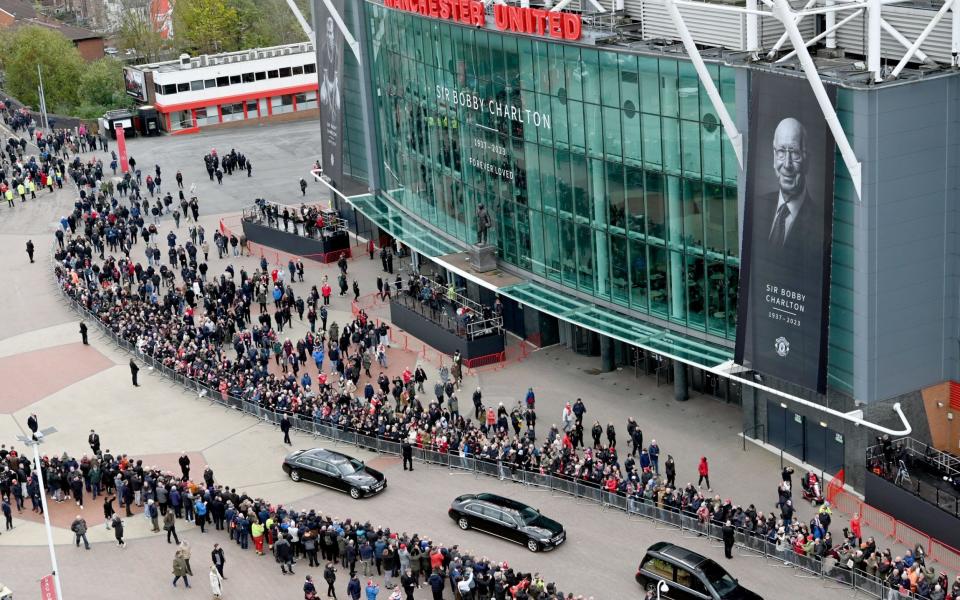 The funeral cortege passes Old Trafford