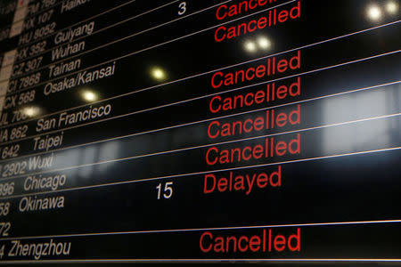 A panel displaying cancelled and delayed flights is seen at a downtown check-in centre as Typhoon Haima approaches in Hong Kong, China, October 21, 2016 . REUTERS/Bobby Yip