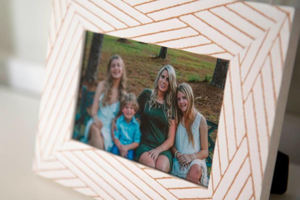 A photo of the Wyatt family sits in Heather Wyatt’s home in Ocean Springs on Tuesday, March 12, 2024. Aubreigh is pictured on her mother Heather’s right.