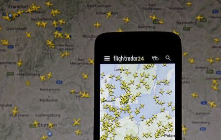 The Flightradar24 application is pictured on a smartphone in front of a computer screen displaying the website in this illustration taken in Zenica, Bosnia and Herzegovina May 18, 2015. REUTERS/ Dado Ruvic