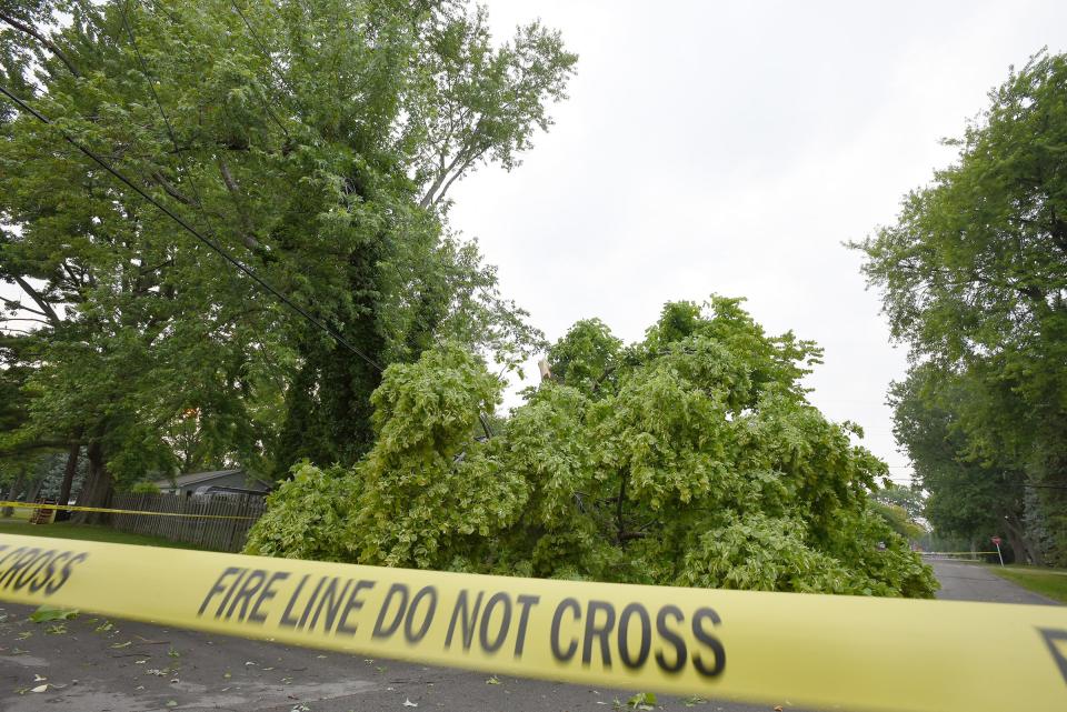 Yellow caution tape marks where wires were down on Third Street and Pleasant View in Detroit Beach, Frenchtown Township,  Thursday evening, June 15, 2023 due to a possible tornado. Frenchtown firefighters had been on the scene.