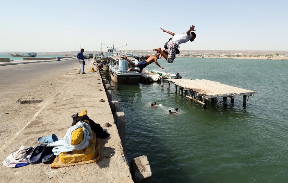 Young Iranians dive into Gulf waters in Chabahar, Iran, on May 11, 2015.