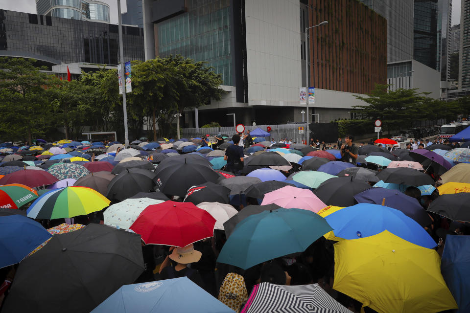 Protesters with umbrellas gather near the Legislative Council as they continuing protest against the unpopular extradition bill in Hong Kong, Monday, June 17, 2019. A member of Hong Kong's Executive Council says the city's leader plans to apologize again over her handling of a highly unpopular extradition bill. (AP Photo/Kin Cheung)