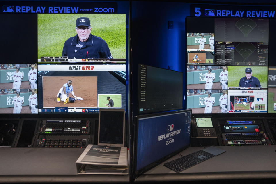 A Major League Baseball umpire is displayed alongside gameplay clips during a demonstration at a Replay Review station at MLB headquarters in New York, Tuesday, March 28, 2023. (AP Photo/John Minchillo)