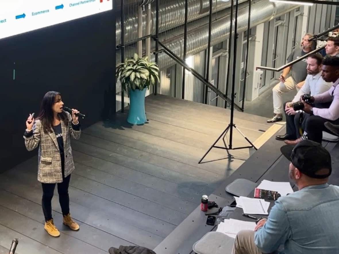 Alina Martin, CEO of Waitwell, makes a pitch to investors at a recent Startup TNT event in Calgary. Martin is seeking $1.3 million in its first round of funding to expand the company. (Bryan Labby/CBC - image credit)