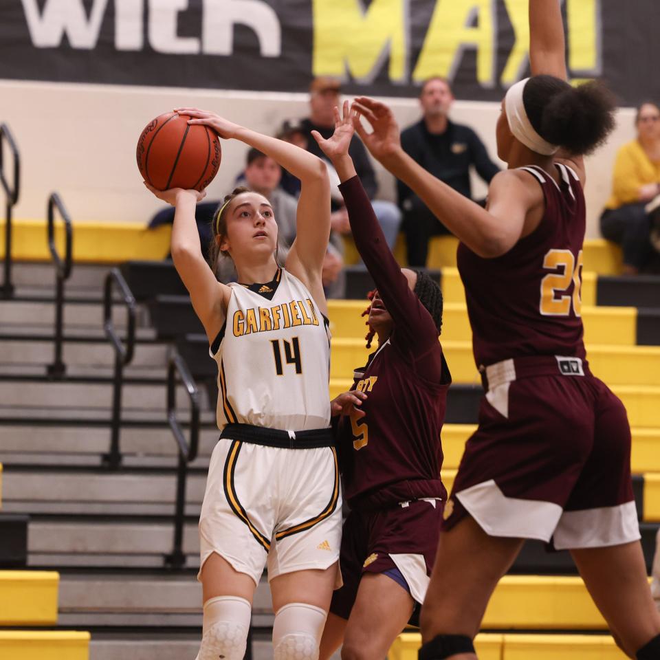 Garfield senior forward Madeline Shirkey shoots a 3-pointer from the corner during Thursday night's basketball game against the Liberty Leopards at James A. Garfield High School.