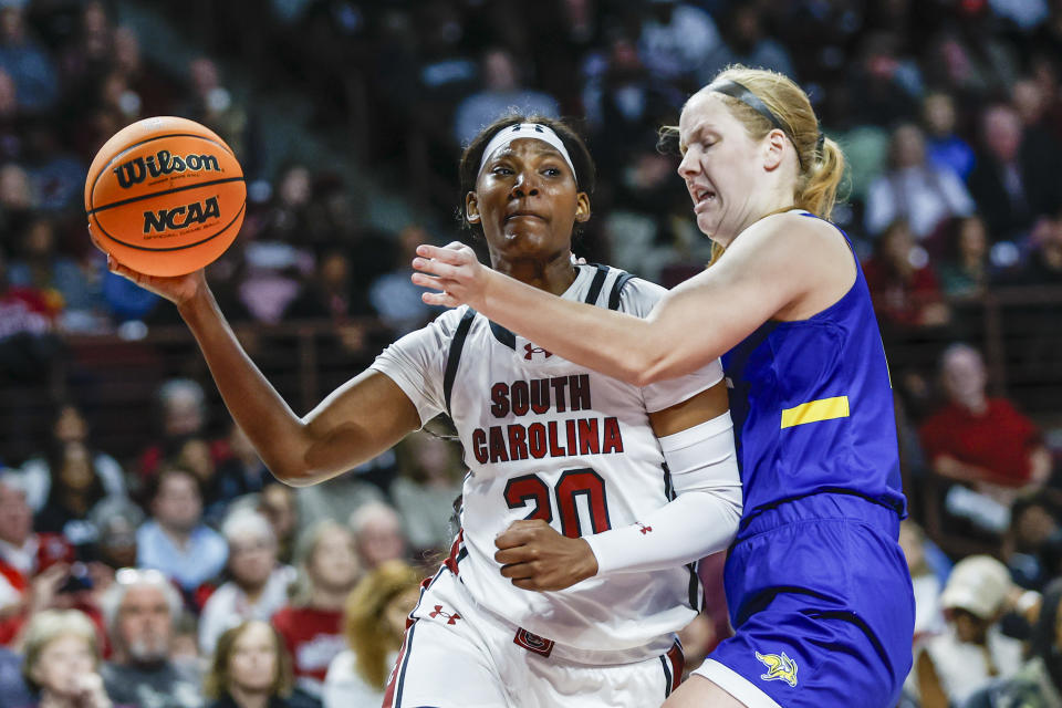 South Carolina forward Sania Feagin, left, passes the ball against South Dakota State forward Tori Nelson, right, during the first half of an NCAA college basketball game in Columbia, S.C., Monday, Nov. 20, 2023. (AP Photo/Nell Redmond)