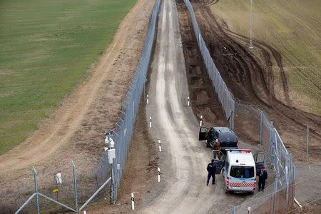 FILE PHOTO: A Hungarian police and soldiers patrol the Hungary-Serbia border, which was recently fortified by a second fence, near the village of Gara, Hungary, March 2, 2017. REUTERS/Laszlo Balogh