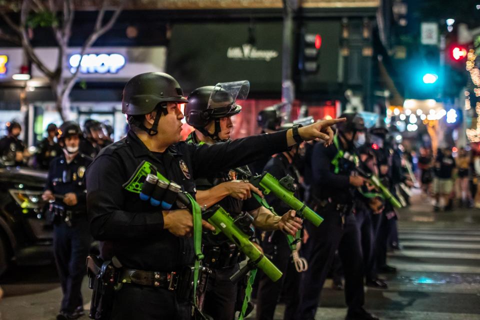 Seen here, police officers take position to disperse LA Rams fans in downtown Los Angeles after the Rams&#39; Super Bowl win.