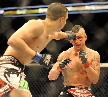 Myles Jury [L] lands a punch on Diego Sanchez [R] at UFC 171. (AP Photo/Matt Strasen)