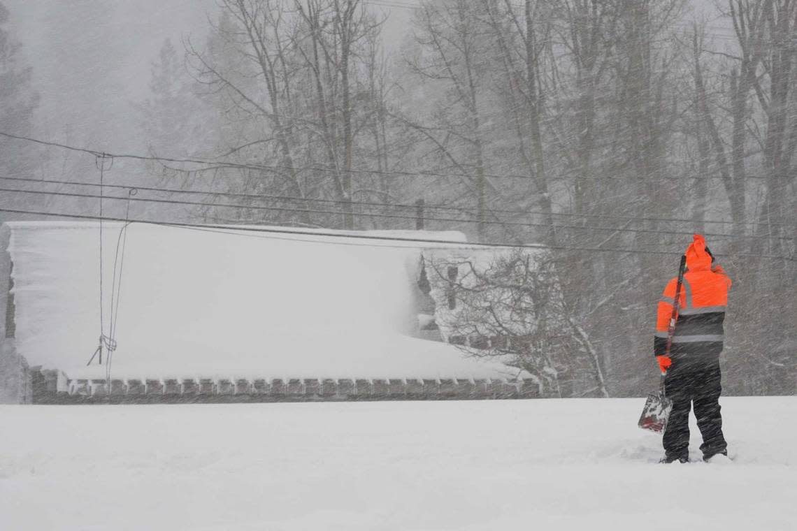 A person uses a shovel trying to clear snow from a property during a storm, Saturday, March 2, 2024, in Truckee, Calif. A powerful blizzard howled Saturday in the Sierra Nevada as the biggest storm of the season shut down a long stretch of Interstate 80 in California and gusty winds and heavy rain hit lower elevations, leaving tens of thousands of homes without power. Brooke Hess-Homeier/AP