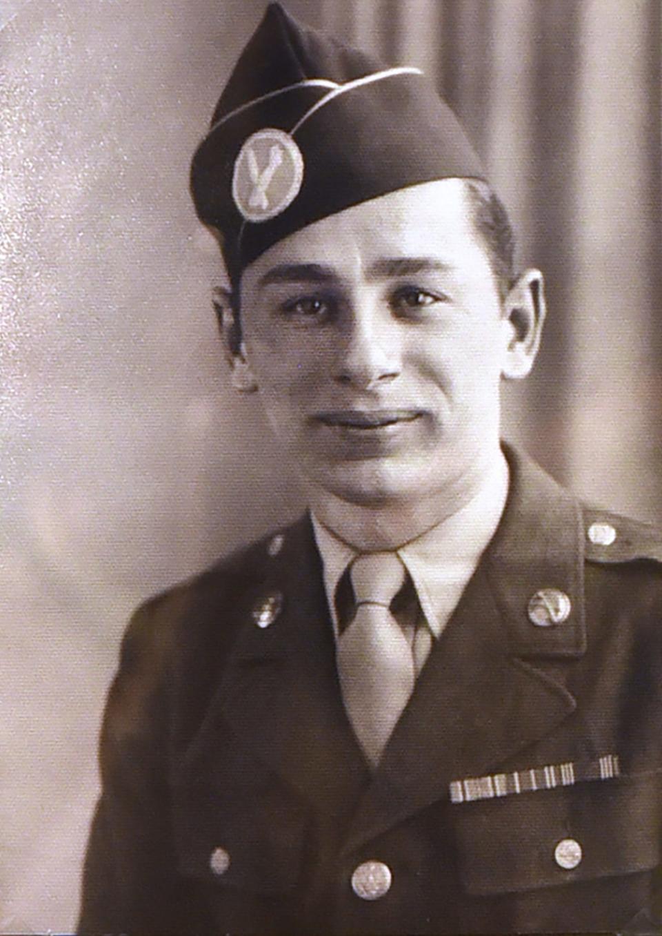 An image of Daniel A. Passarella (age 96, now) of Brick, in a glass frame surrounded by medals including a Purple Heart and badges, photographed at his home in Brick on 05/21/19.