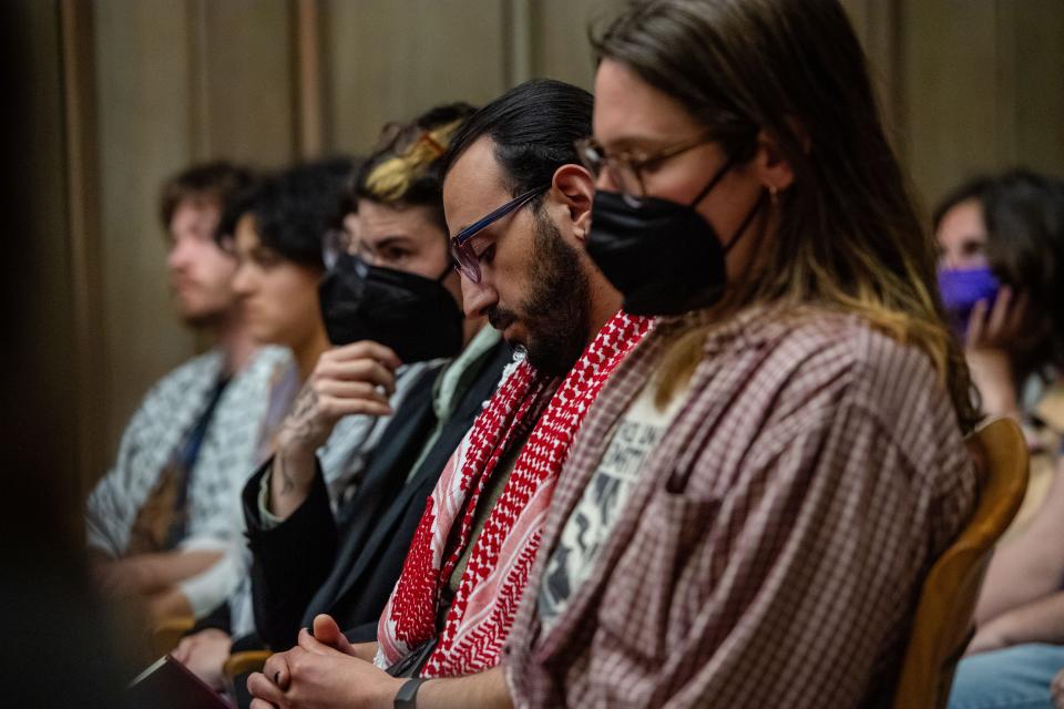 Audience members listen to public comment at Asheville City Council, March 12, 2024.