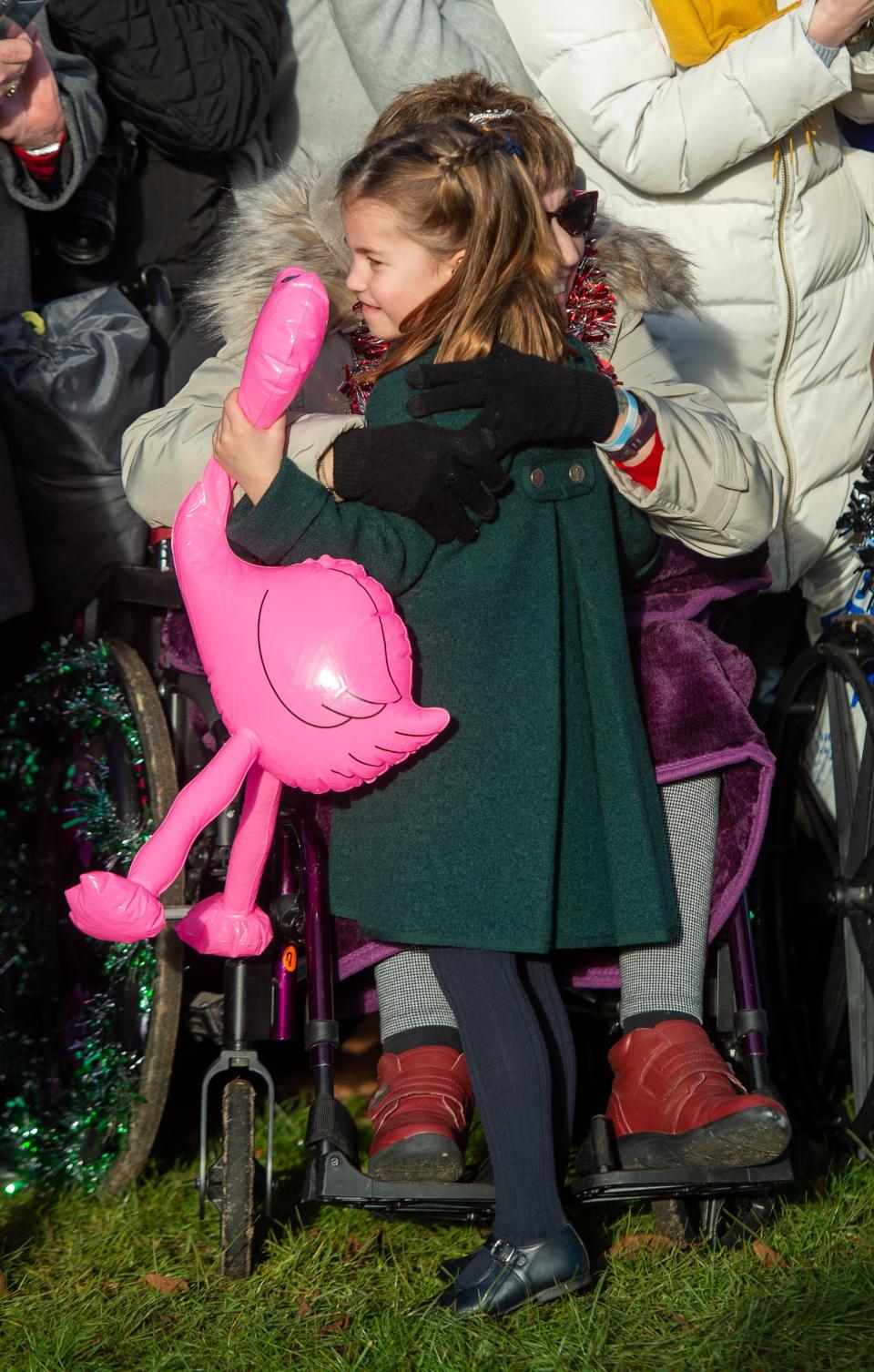 Princess Charlotte hugs a well-wisher—and her flamingo.