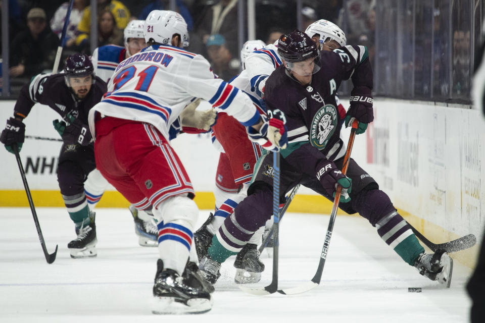 Anaheim Ducks right wing Jakob Silfverberg (33) vies for the puck against New York Rangers center Barclay Goodrow (21) and center Nick Bonino (12) during the first period of an NHL hockey game, Sunday, Jan. 21, 2024, in Anaheim, Calif. (AP Photo/Kyusung Gong)