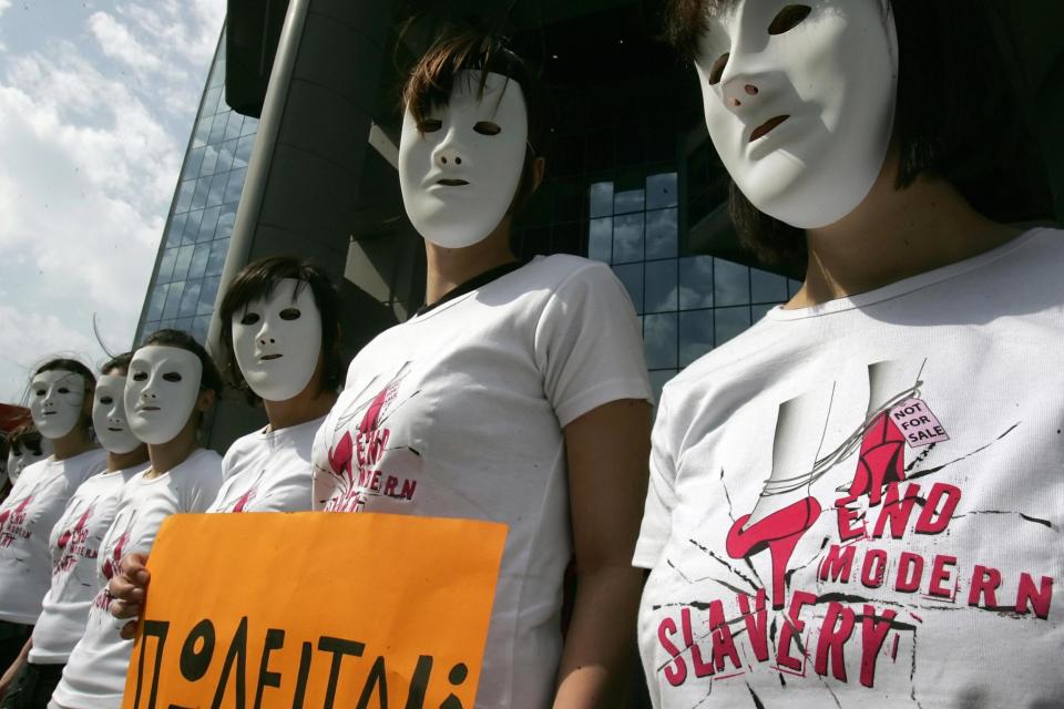 Amnesty International activists wearing T-shirts reading 'end modern slavery' protest against human trafficking in Athens, Greece: LOUISA GOULIAMAKI/AFP via Getty Images