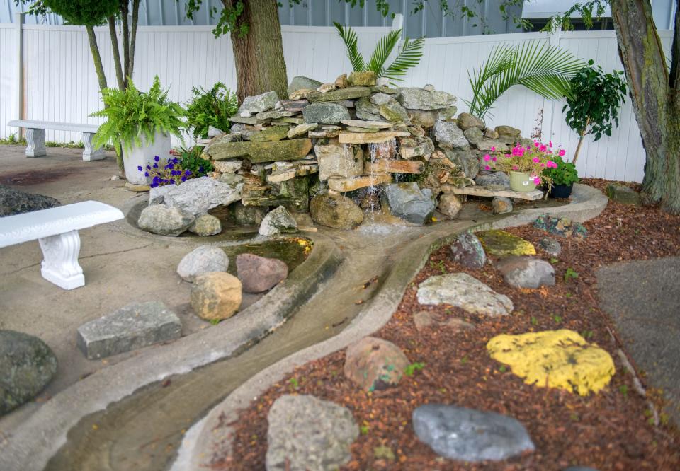 A waterfall adds some elegance to the outdoor dining space at Seasoned Little Eatery on Pioneer Parkway.