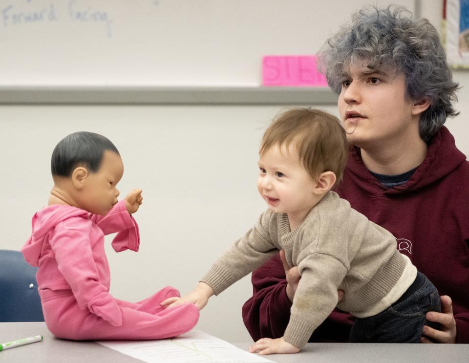 Grayson Adams, 17, holds his 10 month old son, Mateo, during a parenting class at Marcos de Niza High School. The high school offers Teenage Pregnancy Program (TAPP) to help pregnant and parenting teens finish high school.