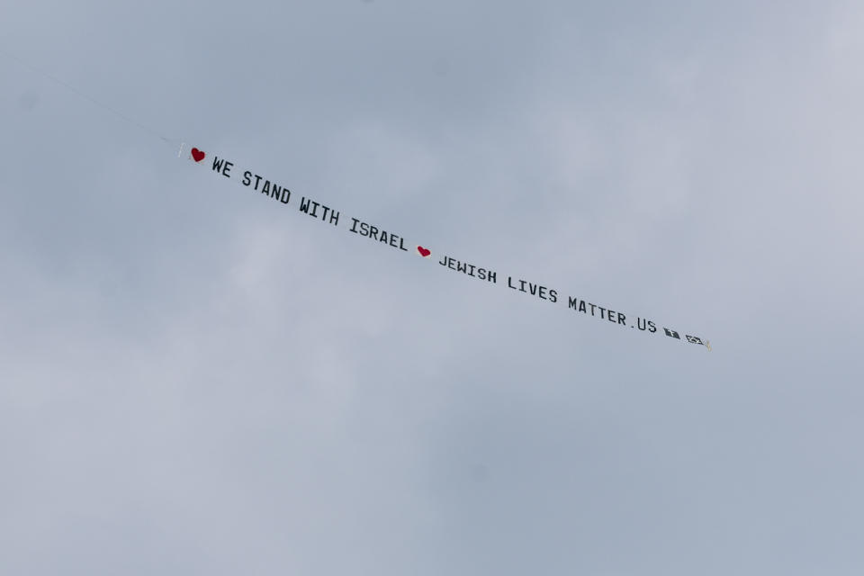 A plane bearing a banner that reads ""We stand with Israel jewishlivesmatter.us" flies overhead before the University of Michigan's Spring 2024 Commencement Ceremony at Michigan Stadium in Ann Arbor, Mich., on Saturday, May 4, 2024. (Jacob Hamilton/Ann Arbor News via AP)