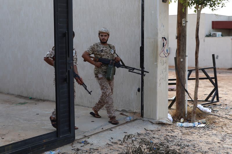 FILE PHOTO: Members of the Libyan internationally recognized government forces carry weapons in Ain Zara, Tripoli