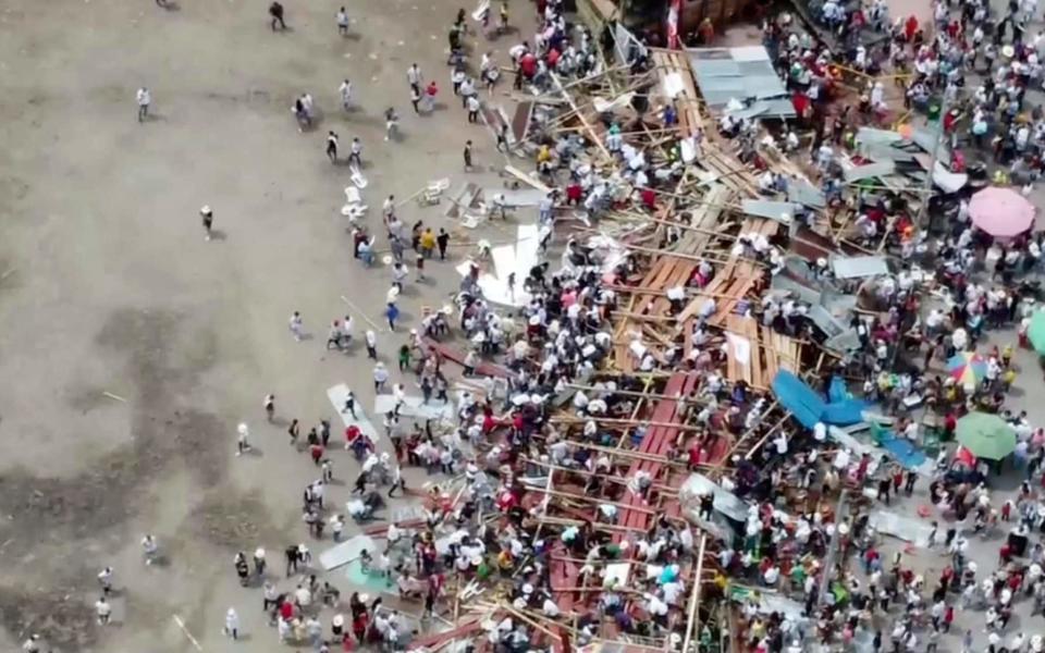 In this image taken from video, spectators are sent plunging to the ground as part of a wooden stand collapses during a bullfight, Sunday, June 26, 2022, at a stadium in the city of El Espinal in Tolima state, central Colombia. (AP Video) - AP Video