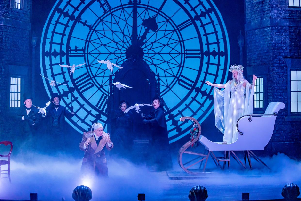 The Ghost of Christmas Past (Maggie Lou Rader, right) appears to Ebenezer Scrooge (Andrew May), accompanied by a flock of screeching birds, in the Playhouse in the Park’s new production of “A Christmas Carol.”