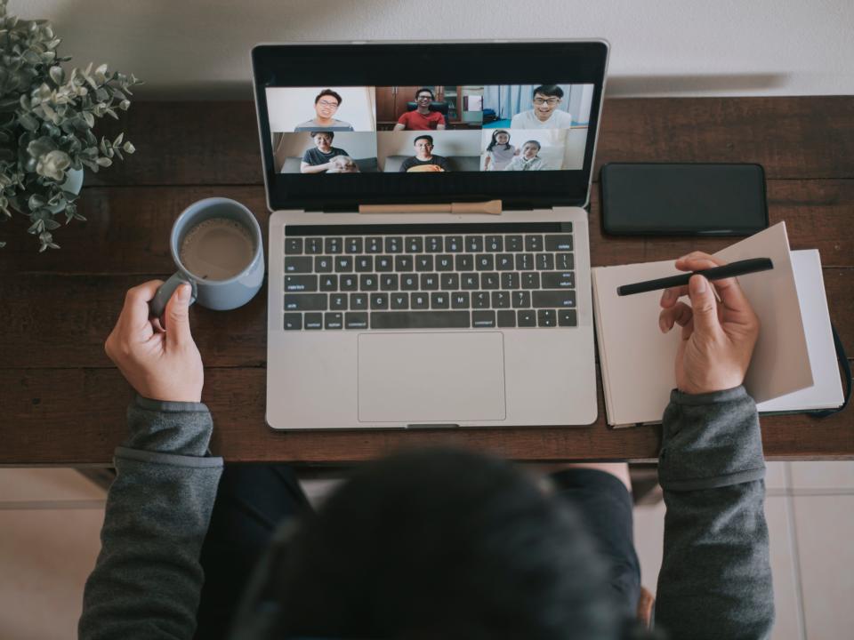 A remote worker attends a virtual meeting on their laptop.