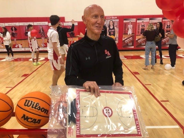 St. Andrew's coach John O'Connell shows off a miniature version of the basketball court that will be named "Johnny O Court" in his honor.