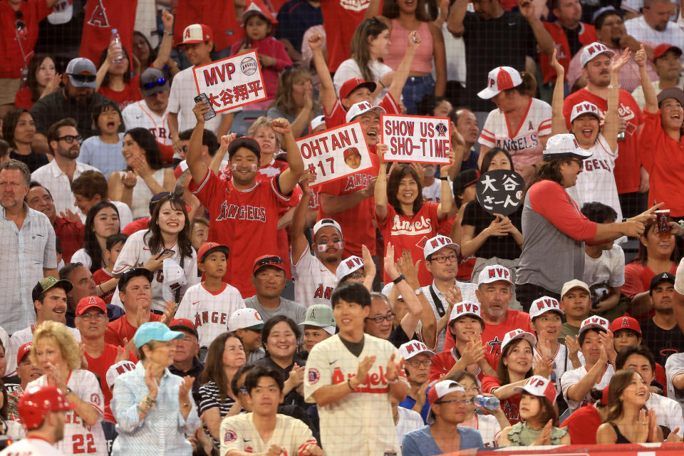 Los Angeles Angels fans celebrate after Shohei Ohtani scored against the Houston Astros on Friday in Anaheim.  (Photo by Sean M. Haffey/Getty Images)