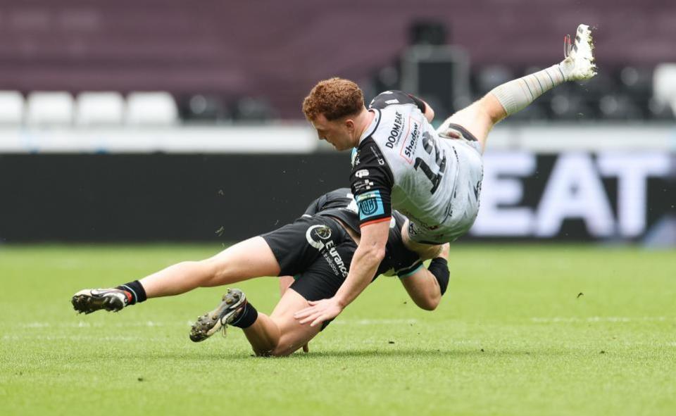 South Wales Argus: STOPPED: Dragons centre Aneurin Owen is tackled at the Ospreys