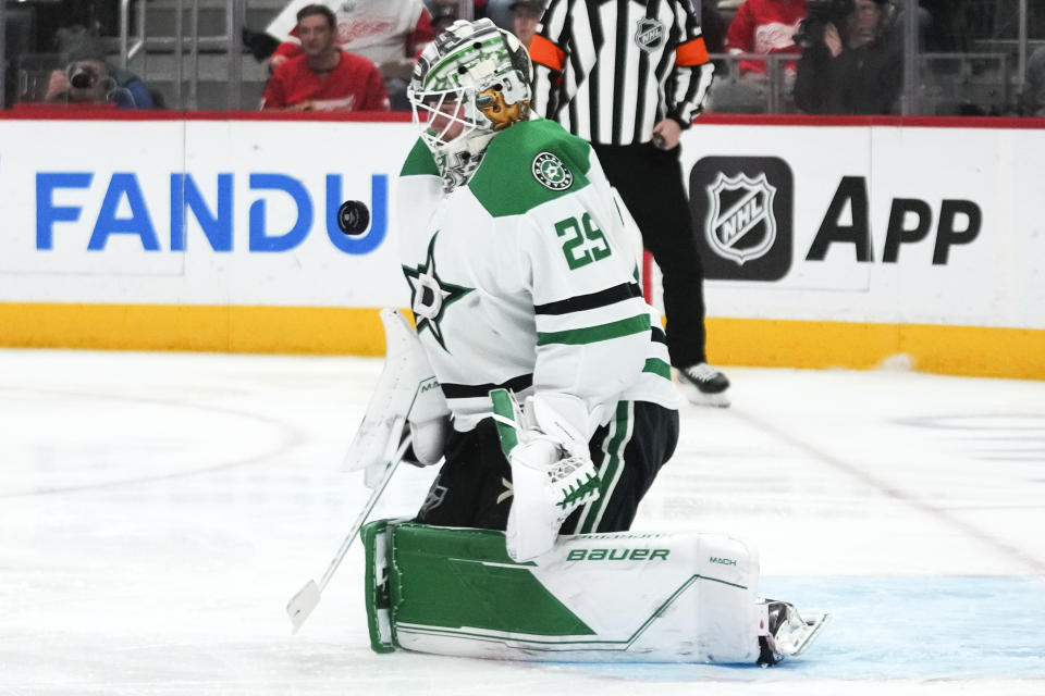 Dallas Stars goaltender Jake Oettinger (29) stops a Detroit Red Wings shot in the second period of an NHL hockey game Tuesday, Jan. 23, 2024, in Detroit. (AP Photo/Paul Sancya)