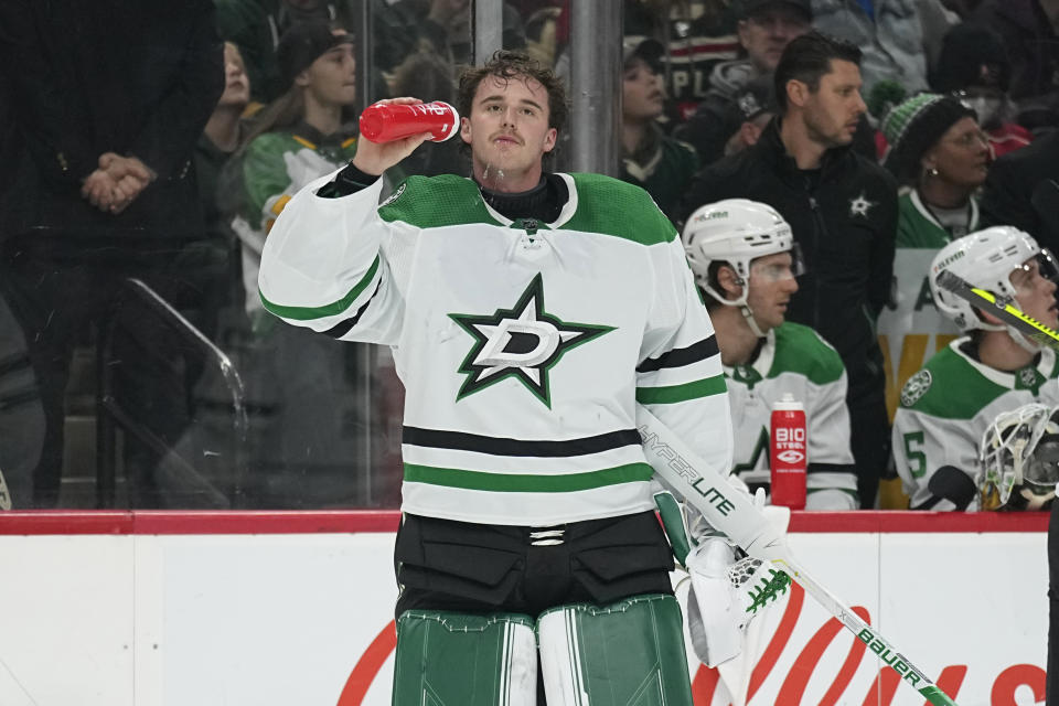 Dallas Stars goaltender Jake Oettinger (29) hydrates during an ice-cleaning break during the first period of an NHL hockey game against the Minnesota Wild, Thursday, Dec. 29, 2022, in St. Paul, Minn. (AP Photo/Abbie Parr)