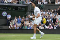 Serbia's Novak Djokovic celebrates after beating Russia's Andrey Rublev to win their men's singles match on day nine of the Wimbledon tennis championships in London, Tuesday, July 11, 2023. (AP Photo/Alberto Pezzali)