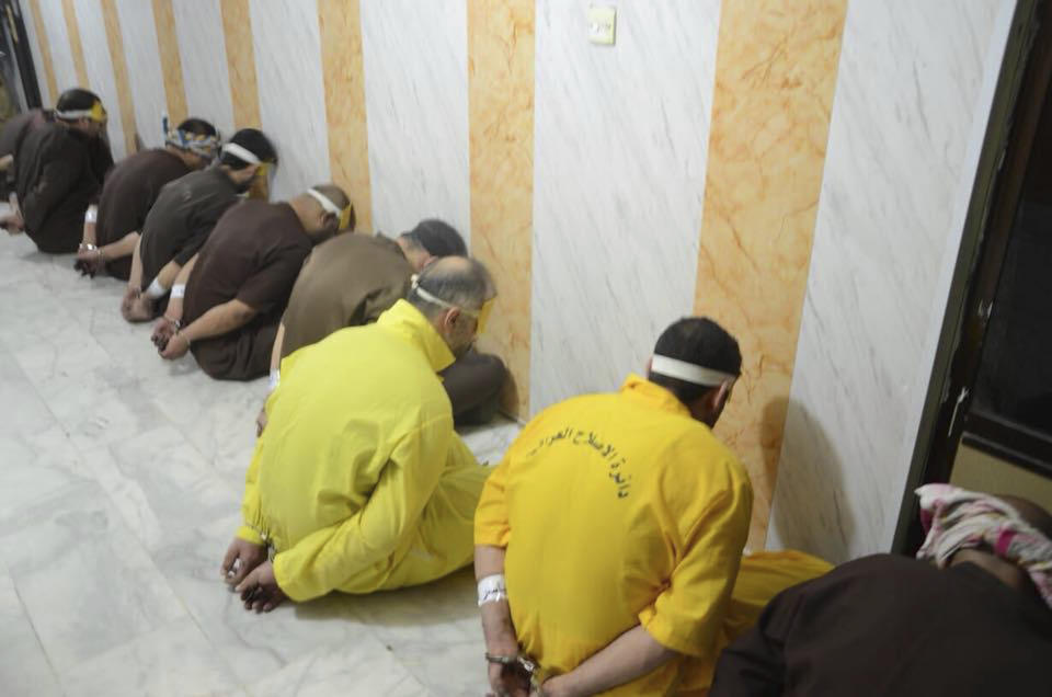 FILE - In this file photo released by Iraq's Ministry of Justice on June 29, 2018, blindfolded prisoners await their executions in Iraq. A report released by Amnesty International on Wednesday, April 21, 2021, said the number of executions worldwide in 2020 plummeted to its lowest level in at least a decade. But the report said four states in the Middle East — Iran, Egypt, Iraq and Saudi Arabia respectively — topped the global list and pressed on with shootings, beheadings and hangings, ignoring pleas by rights groups to halt executions during the pandemic. (Iraq Ministry of Justice via AP, File)