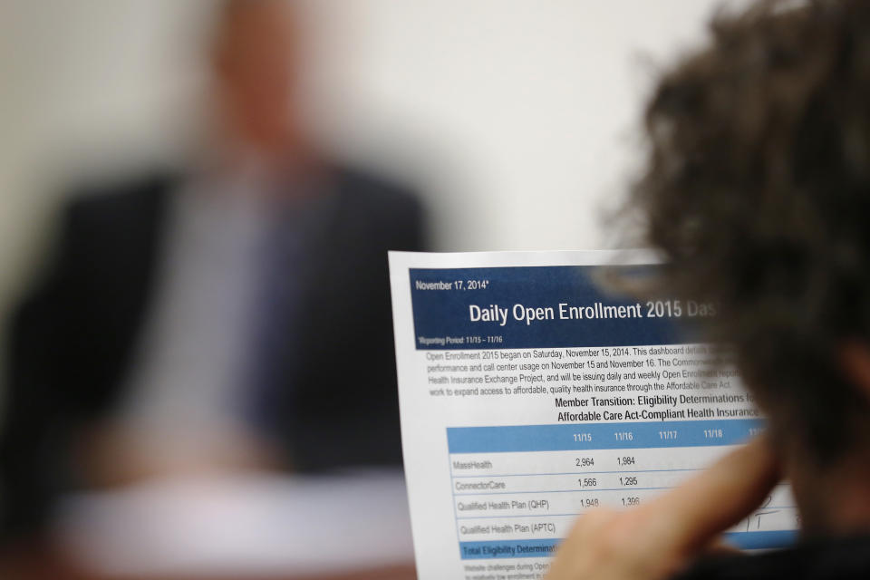 A reporter reads a summary of the performance and usage over the first two days of open enrollment of the Massachusetts Health Connector website, the state's health insurance website under the Affordable Care Act or Obamacare, during a briefing for reporters in Boston, Massachusetts November 17, 2014.  U.S. President Barack Obama on Sunday defended the transparency of his signature healthcare law, after one of the White House's advisors on the reform said the law passed, in part, because of the "stupidity" of the American voters.        REUTERS/Brian Snyder    (UNITED STATES - Tags: HEALTH POLITICS)