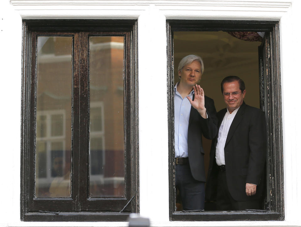 FILE - In this Sunday, June 16, 2013 file photo, WikiLeaks founder Julian Assange, left, appears with Ecuador's Foreign Minister Ricardo Patino on the balcony of the Ecuadorian Embassy in London. Judge Vanessa Baraitser has ruled that Julian Assange cannot be extradited to the US. because of concerns about his mental health, it was reported on Monday, Jan. 4, 2021. Assange had been charged under the US's 1917 Espionage Act for "unlawfully obtaining and disclosing classified documents related to the national defence". (AP Photo/Frank Augstein, file)