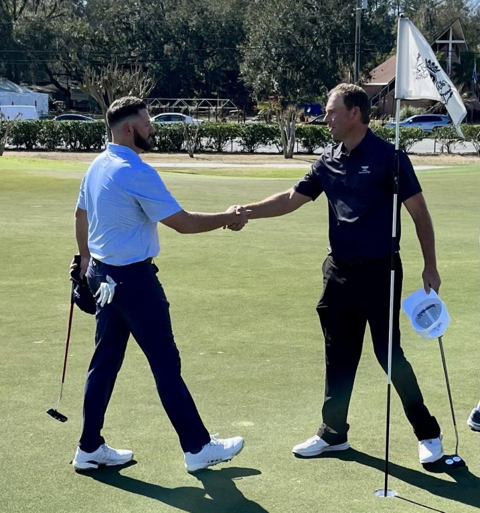 Chris Henderson (right) of the Underwood Cup amateur congratulates Jake Etherton of the pro team after Etherton and Josh Wolfe won a doubles match at the San Jose Country Club on Monday.