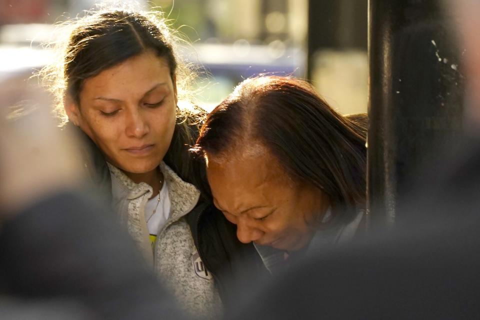 Two women console each other