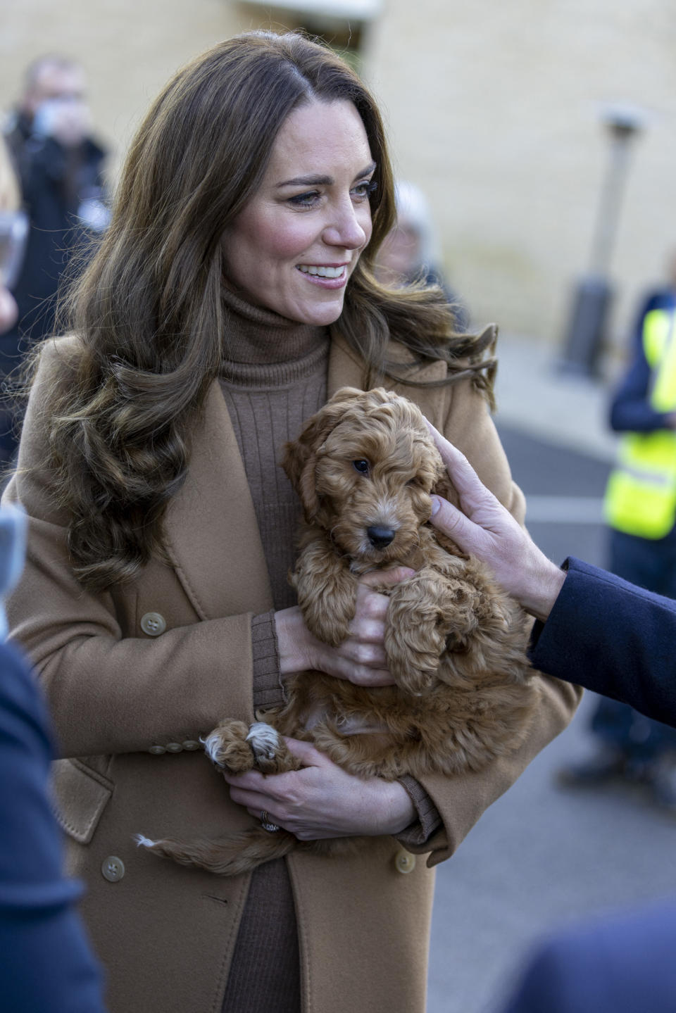 Britain's Catherine, Duchess of Cambridge, holds a therapy puppy, before unveiling it's name, Alfie, to members of staff during her visit to Clitheroe Community Hospital in north east England on January 20, 2022, to hear about their experiences during the Covid-19 pandemic. - The puppy, funded through the hospital charity ELHT&Me using a grant from NHS Charities Together, will be used to support the wellbeing of staff and patients at the hospital. (Photo by James Glossop / POOL / AFP) (Photo by JAMES GLOSSOP/POOL/AFP via Getty Images)