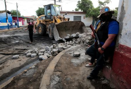 A pro-government supporter stands near a barricade after clashes with demonstrators in the indigenous community of Monimbo in Masaya, Nicaragua July 17, 2018. REUTERS/Oswaldo Rivas