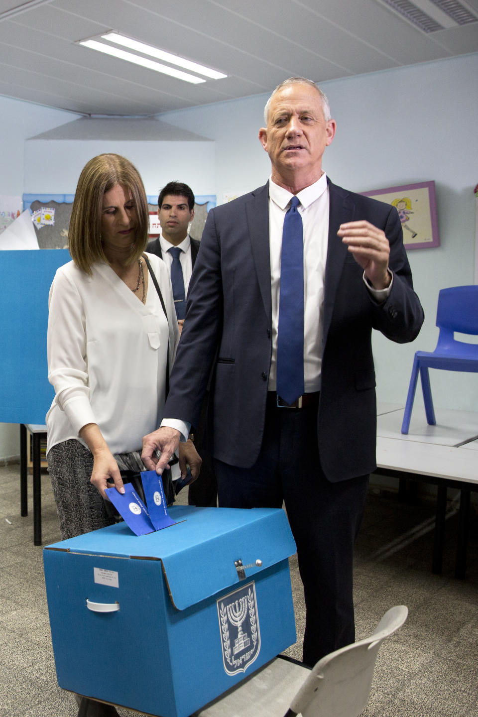 Blue and White party leader Benny Gantz, right, casts his vote with his wife Revital Gantz during Israel's parliamentary elections in Rosh Haayin, Israel, Tuesday, April 9, 2019. (AP Photo/Sebastian Scheiner)